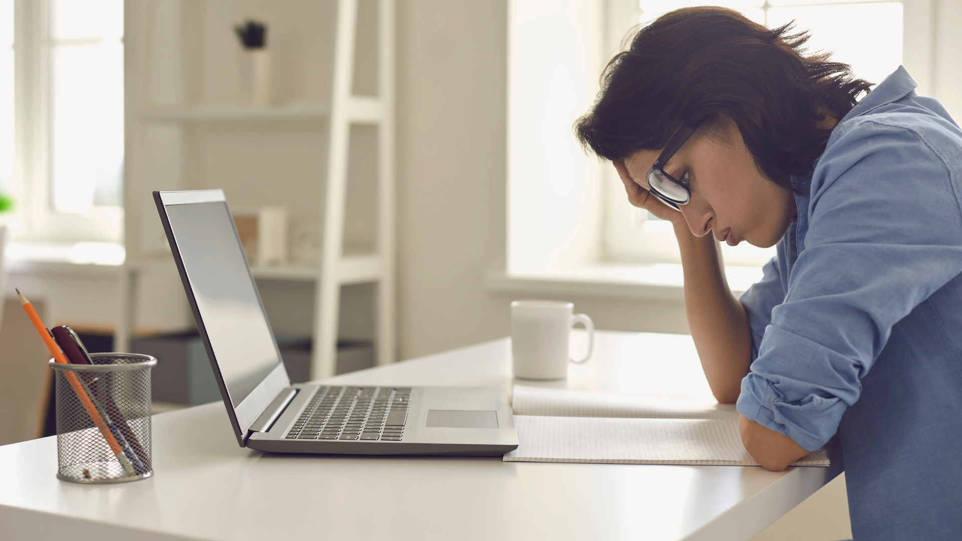a worried woman in front of her laptop